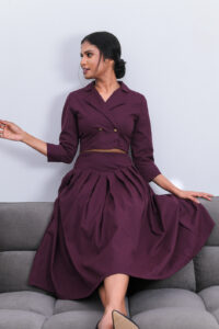 Vera - Pleated Midi Skirt is made from Purplish Red thick Cotton. It is Midi Length and has pleats and Noori - Cropped Blazer Top is Double Breasted , with 3/4 length sleeves and a crop top