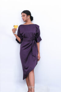 Jamie - Midi Kaftan Dress is made from purple Satin and has an asymmetrical hem and sash belt